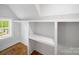Walk-in closet with built-in shelving, hardwood floors, white walls, and a window at 217 S Green St, Wadesboro, NC 28170