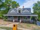 Charming two-story home with a inviting covered front porch, brick accents, and landscaped yard at 217 S Green St, Wadesboro, NC 28170