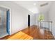 Upstairs hallway features hardwood floors, white walls, and natural light from an exterior window at 217 S Green St, Wadesboro, NC 28170