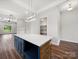Open-concept kitchen with a large island, quartz countertops, stainless steel appliances, and modern lighting at 217 S Green St, Wadesboro, NC 28170