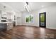 Modern open kitchen with white cabinets, stainless steel appliances, and hardwood flooring throughout at 217 S Green St, Wadesboro, NC 28170