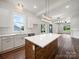 Spacious kitchen featuring white cabinetry, quartz countertops, stainless steel appliances, and an island at 217 S Green St, Wadesboro, NC 28170