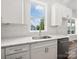Bright kitchen featuring white cabinetry, quartz countertops, stainless steel appliances, and a designer backsplash at 217 S Green St, Wadesboro, NC 28170