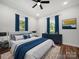 Comfortable main bedroom featuring a ceiling fan, hardwood floors, and natural light from the two windows at 217 S Green St, Wadesboro, NC 28170