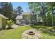 Expansive backyard showcasing lush greenery, a spacious deck, and outdoor relaxation at 2224 Clonmel Pl, Charlotte, NC 28262