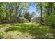 Large backyard featuring lush lawn, a shed, and the house offering outdoor possibilities at 2224 Clonmel Pl, Charlotte, NC 28262