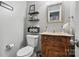 Charming bathroom with decorative shelves, toilet, and vanity at 2224 Clonmel Pl, Charlotte, NC 28262