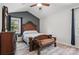 Bedroom with decorative headboard, bench, ceiling fan, and natural light at 2224 Clonmel Pl, Charlotte, NC 28262