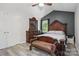 Bedroom with decorative headboard, bench, and natural light at 2224 Clonmel Pl, Charlotte, NC 28262