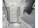 Inviting foyer with a decorative front door, black and white staircase, and contemporary light fixtures at 2224 Clonmel Pl, Charlotte, NC 28262