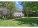 Beautiful two-story home with gray siding, black shutters, and a lush green lawn, offering classic suburban charm at 2224 Clonmel Pl, Charlotte, NC 28262
