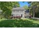 Charming two-story home featuring gray siding, black shutters, and a well-manicured lawn, creating a welcoming curb appeal at 2224 Clonmel Pl, Charlotte, NC 28262