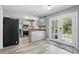 Bright kitchen featuring stainless appliances, gray cabinets and countertops, LVP floors, and backyard access at 2224 Clonmel Pl, Charlotte, NC 28262