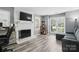 Inviting living room with a fireplace, large windows for natural light, and LVP flooring at 2224 Clonmel Pl, Charlotte, NC 28262