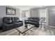 Spacious living room with comfortable seating, a large coffee table, and plenty of natural light, perfect for gatherings at 2224 Clonmel Pl, Charlotte, NC 28262