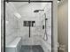Modern shower with glass enclosure, bench, and unique tile at 2224 Clonmel Pl, Charlotte, NC 28262