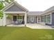 Wide view of back of the home with an outdoor patio area and a lush lawn at 2306 Wesley Landing Rd, Waxhaw, NC 28173