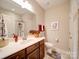 Well-lit bathroom with a single vanity, tiled shower, and modern fixtures at 2306 Wesley Landing Rd, Waxhaw, NC 28173