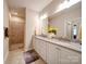 Bright bathroom with a double vanity, granite countertop, and tiled walk-in shower at 2306 Wesley Landing Rd, Waxhaw, NC 28173