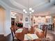Elegant dining area featuring a chandelier, hardwood floors, and access to the modern kitchen at 2306 Wesley Landing Rd, Waxhaw, NC 28173