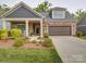 Charming home showcasing stone accents, a covered porch, and a well-manicured front yard at 2306 Wesley Landing Rd, Waxhaw, NC 28173