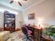 Cozy home office with a dark wood desk, bookcase, and comfortable seating area with natural light at 2306 Wesley Landing Rd, Waxhaw, NC 28173