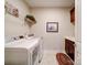 Functional laundry room featuring a washer, dryer, shelving, and a sink with cabinets at 2306 Wesley Landing Rd, Waxhaw, NC 28173