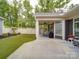 Covered patio with outdoor seating, a grill, and a view of the lush backyard at 2306 Wesley Landing Rd, Waxhaw, NC 28173