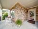 Inviting porch with stone accents and rocking chairs create a welcoming entrance at 2306 Wesley Landing Rd, Waxhaw, NC 28173