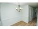 Dining area featuring chair rail and modern chandelier at 2332 Kenmore Ave, Charlotte, NC 28204