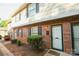 Charming brick townhouse features black shutters, neat landscaping, and inviting entryway at 2332 Kenmore Ave, Charlotte, NC 28204