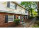 Traditional brick townhouse with black shutters, and landscaped entrance at 2332 Kenmore Ave, Charlotte, NC 28204