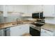 Updated kitchen with stainless steel appliances, granite countertops, and stylish backsplash at 2332 Kenmore Ave, Charlotte, NC 28204
