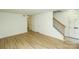 Bright, open living room featuring wood-look floors and staircase at 2332 Kenmore Ave, Charlotte, NC 28204