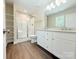 Bright bathroom features a double vanity, glass enclosed shower, and built in storage shelves at 288 Tram Rd, Lancaster, SC 29720