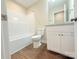 Bright bathroom with white fixtures, vanity, granite counters and tub with shower at 288 Tram Rd, Lancaster, SC 29720