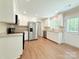 Well-lit kitchen with stainless steel appliances, granite counters, and wood-look flooring at 288 Tram Rd, Lancaster, SC 29720