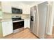 Modern kitchen featuring stainless steel appliances, white cabinets, and wood floors at 288 Tram Rd, Lancaster, SC 29720