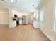 Open-concept kitchen with stainless steel appliances, white cabinetry, and ample counter space at 288 Tram Rd, Lancaster, SC 29720