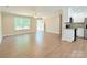 Inviting living area flowing into a modern kitchen, featuring wood floors and ample natural light at 288 Tram Rd, Lancaster, SC 29720