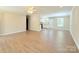 Open-concept living space with hardwood floors, a ceiling fan, and views into the modern kitchen at 288 Tram Rd, Lancaster, SC 29720