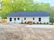 Rear view of a white home with a dark roof and a newly poured concrete pad at 288 Tram Rd, Lancaster, SC 29720