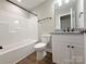 Bright bathroom featuring a shower-tub combo and a white vanity with a gray countertop at 296 Tram Rd, Lancaster, SC 29720