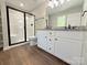 Bathroom featuring dual sinks, granite countertops, walk-in shower, and black hardware at 296 Tram Rd, Lancaster, SC 29720