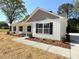 Charming single-story home featuring white siding, black shutters, and manicured landscaping at 296 Tram Rd, Lancaster, SC 29720