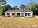 Well-maintained single story home with a welcoming front porch and freshly mulched landscaping at 296 Tram Rd, Lancaster, SC 29720