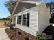 A beautiful house with white siding, black shutters, and manicured landscaping at 296 Tram Rd, Lancaster, SC 29720