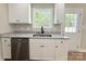 Modern kitchen featuring white cabinetry, granite countertops, and stainless steel dishwasher at 296 Tram Rd, Lancaster, SC 29720