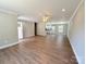 Open-concept living area with new wood floors, ceiling fan, and lots of natural light at 296 Tram Rd, Lancaster, SC 29720