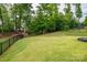Spacious backyard with an iron fence and lush trees at 3017 Winged Teal Ct, Belmont, NC 28012